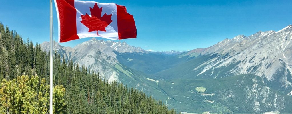 Canadian flag overlooking mountains