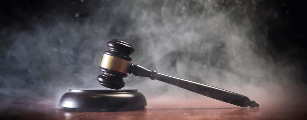 gavel sitting on a desk with smoke surrounding it
