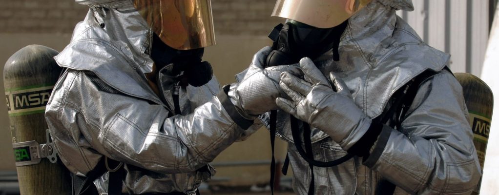 Two people in hazmat suits