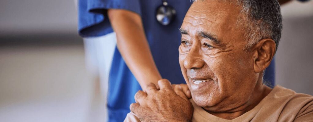 A doctor puts her hand on a patient's shoulder