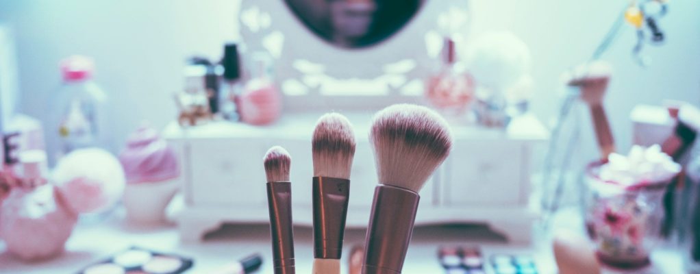 Makeup brushed in front of makeup counter