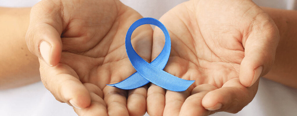 hands holding a blue awareness ribbon
