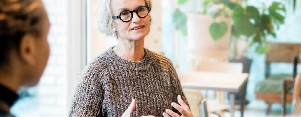 An older woman speaks in a support group