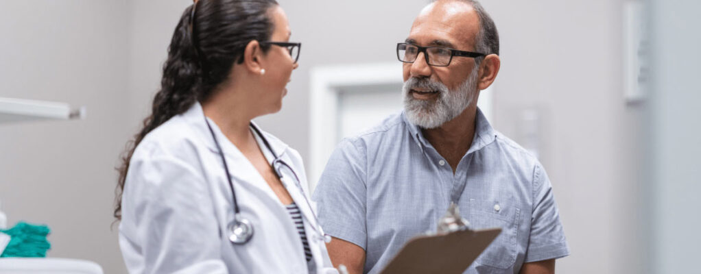 Doctor talking to patient holding clipboard