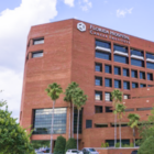 The tall, brown building of AdventHealth Cancer Institute